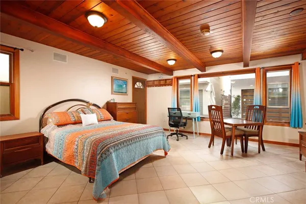 a bedroom with a bed and a large window