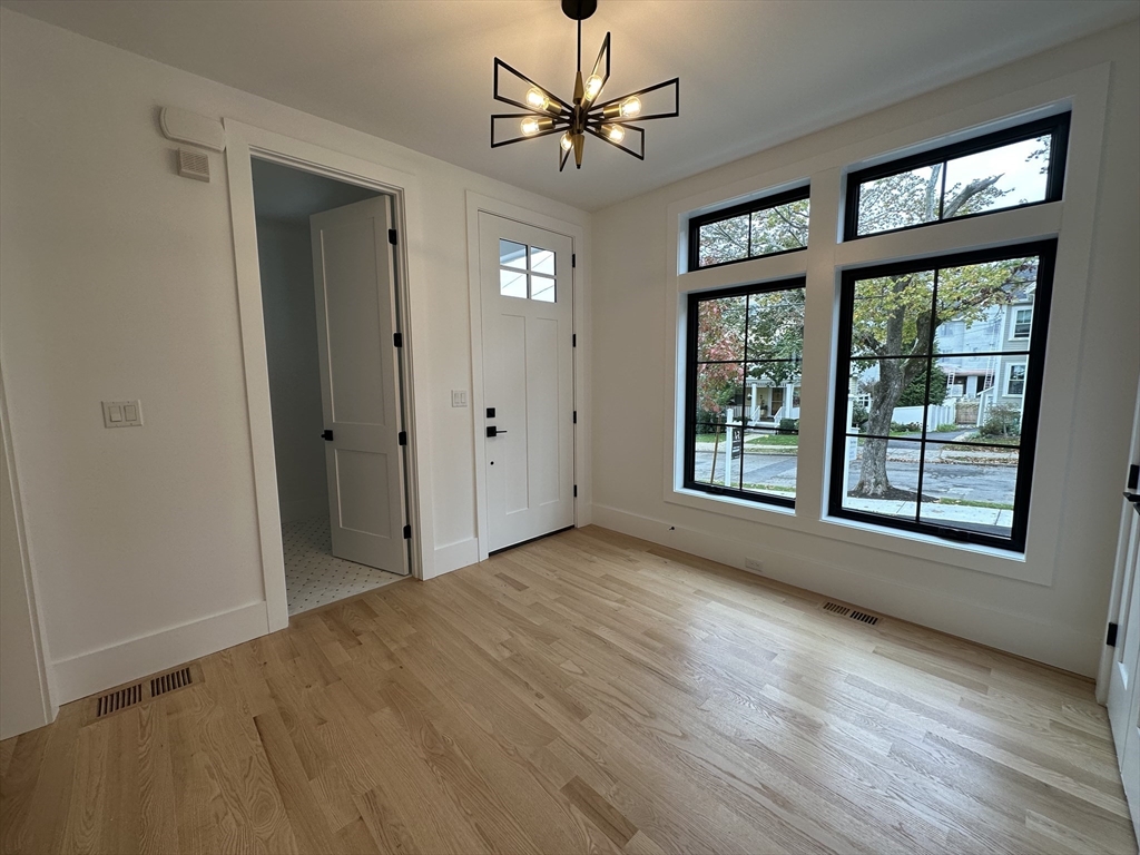 20 Crescent Road, Unit 20 Needham, MA 02494 - Photo 2 of 33 a view of a livingroom with a window and wooden floor