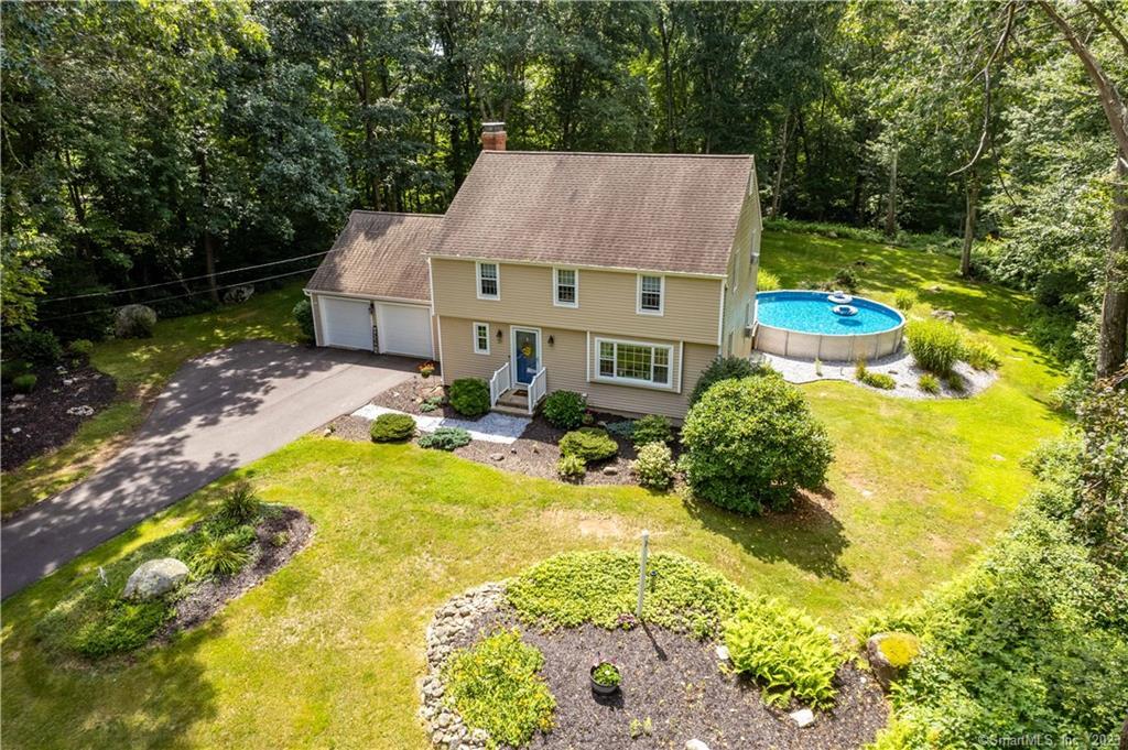 a view of a house with pool and sitting area