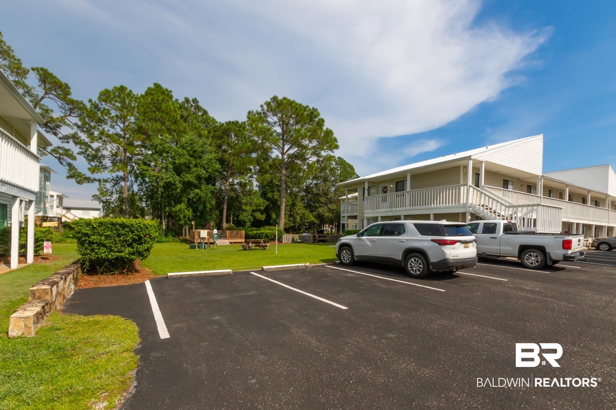 25925 -C Canal Road, Unit 203 Orange Beach, AL 36561 - Photo 43 of 57 View of parking / parking lot with a lawn