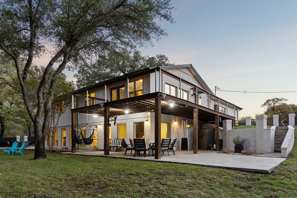 7342 Briar Road Azle, TX 76020 - Photo 25 of 40 Back house at dusk featuring covered batio, upstairs deck and zen garden