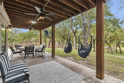 a view of a backyard with sitting area
