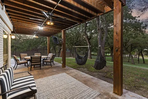 a view of a backyard with table and chairs and a fire pit