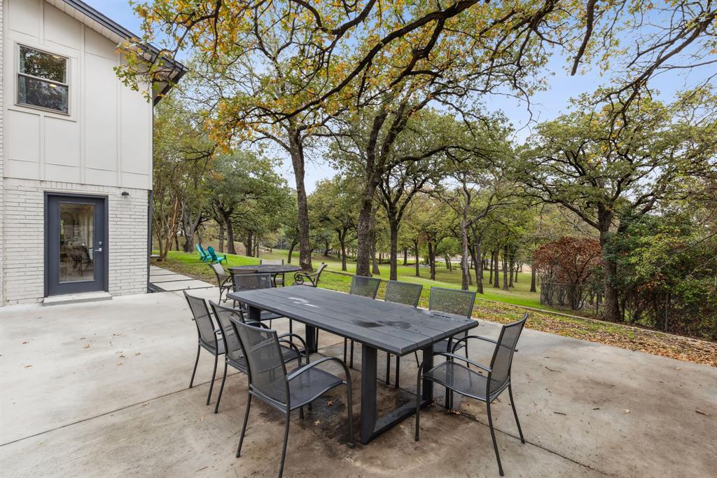 7342 Briar Road Azle, TX 76020 - Photo 30 of 40 a view of a backyard with table and chairs and a fire pit