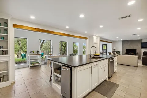 a kitchen with kitchen island granite countertop a sink and counter top space