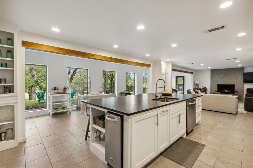 7342 Briar Road Azle, TX 76020 - Photo 4 of 40 a kitchen with kitchen island granite countertop a sink and counter top space