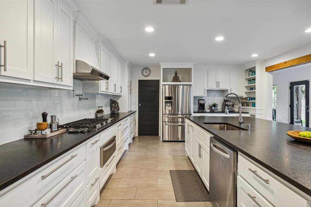 7342 Briar Road Azle, TX 76020 - Photo 7 of 40 a large kitchen with stainless steel appliances granite countertop a sink and cabinets