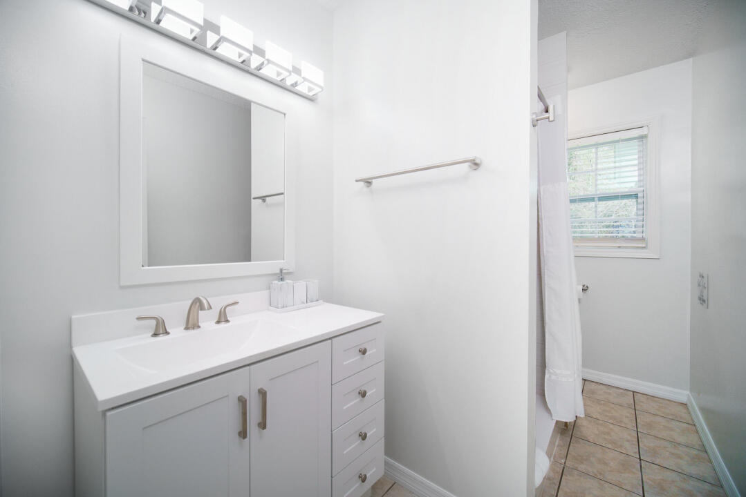 107 Lighthouse Road North Jacksonville, FL 32225 - Photo 26 of 43 a bathroom with a sink a mirror and a shower