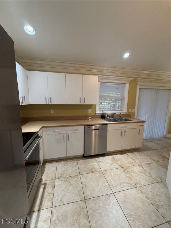 4621 30th Street Southwest Lehigh Acres, FL 33973 - Photo 4 of 8 a large kitchen with granite countertop a stove a sink dishwasher and a refrigerator