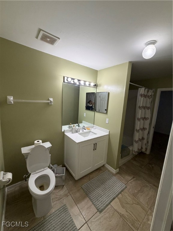 4621 30th Street Southwest Lehigh Acres, FL 33973 - Photo 7 of 8 a bathroom with a toilet sink and mirror