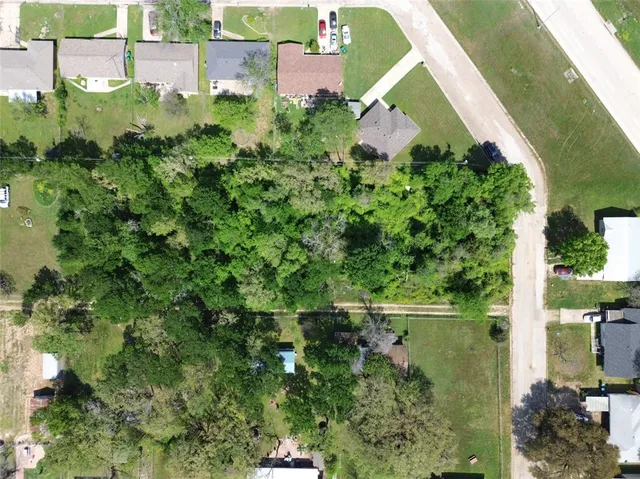 an aerial view of a house with a yard and outdoor space