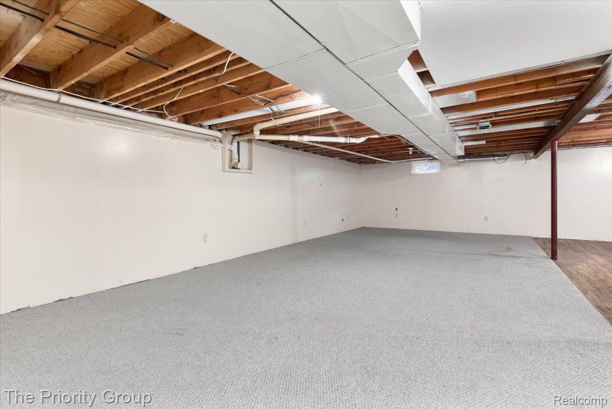 11679 Milford Road Holly, MI 48442 - Photo 25 of 34 Finished basement space with extra storage