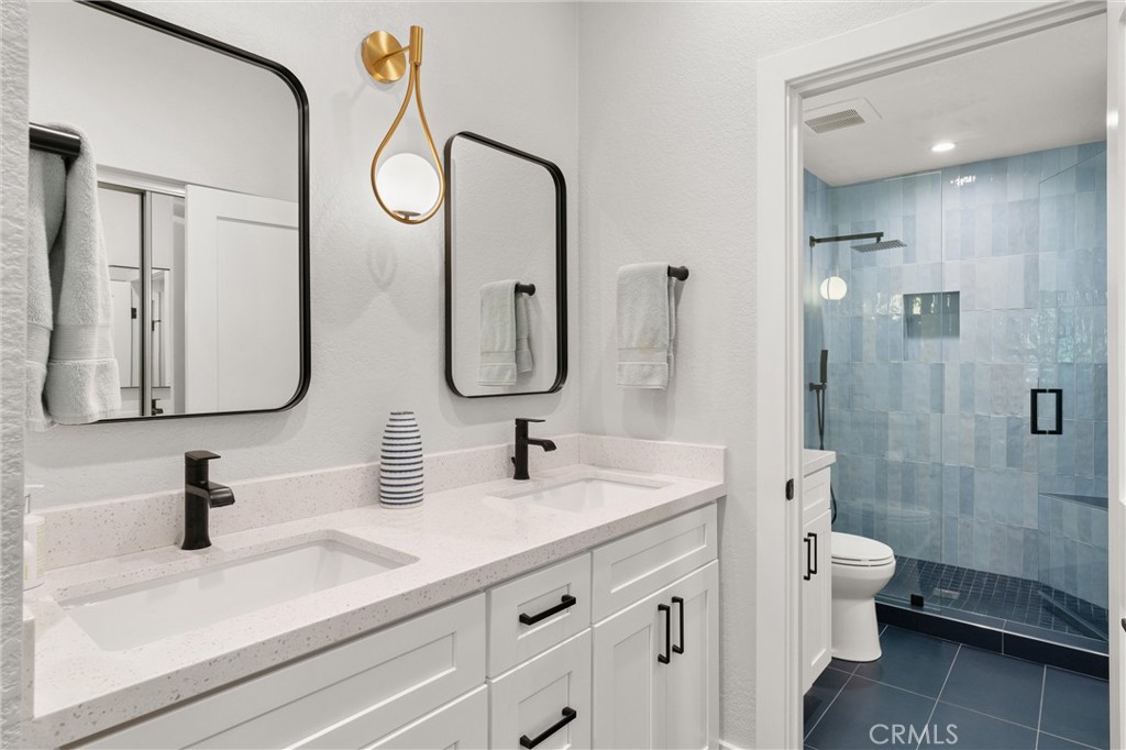 26 Sunbridge Place Dana Point, CA 92629 - Photo 17 of 39 a bathroom with a double vanity sink mirror double and toilet