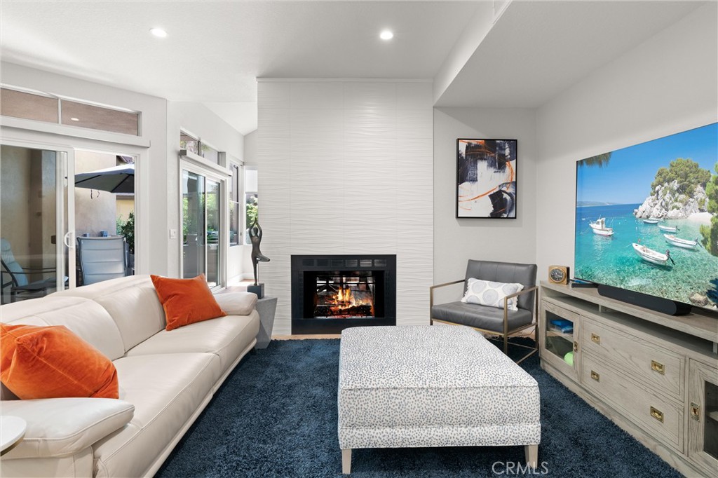 26 Sunbridge Place Dana Point, CA 92629 - Photo 2 of 39 a living room with furniture and a fireplace