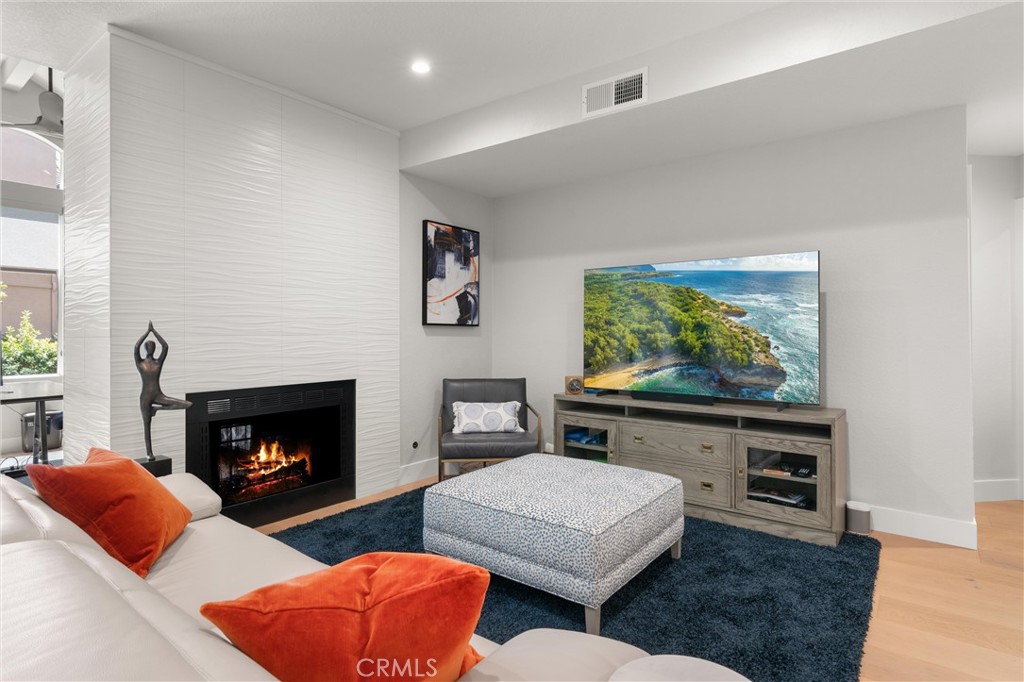 26 Sunbridge Place Dana Point, CA 92629 - Photo 4 of 39 a living room with furniture fireplace and flat screen tv