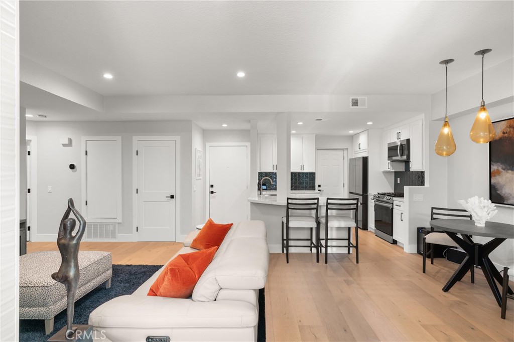 26 Sunbridge Place Dana Point, CA 92629 - Photo 7 of 39 a living room with furniture kitchen view and a wooden floor