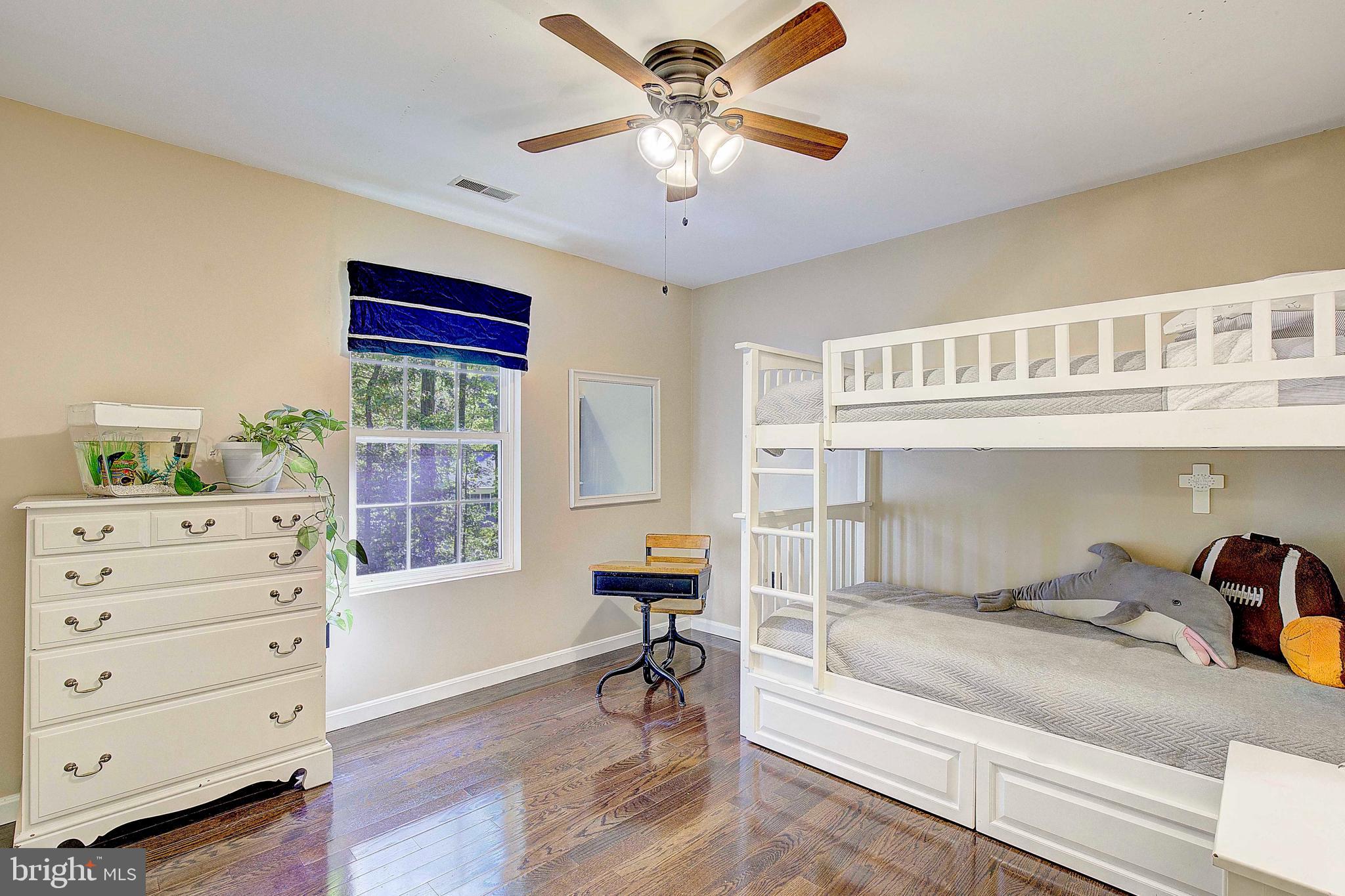 205 Walnut Creek Road Huntingtown, MD 20639 - Photo 26 of 48 a bedroom with a bed and a chandelier