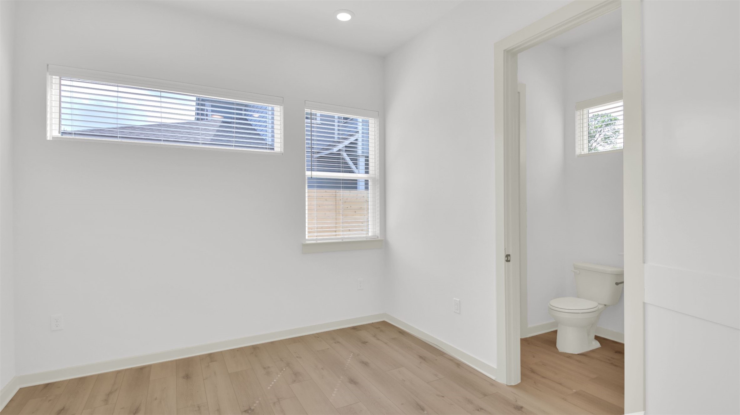 7208 Providence Avenue, Unit 1 Austin, TX 78752 - Photo 12 of 26 This room features light wood-style flooring, white walls, and a recessed ceiling light