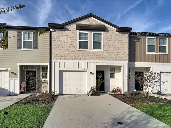a front view of a house with a yard and garage