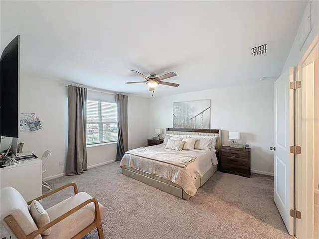 a bedroom with a bed and a couch