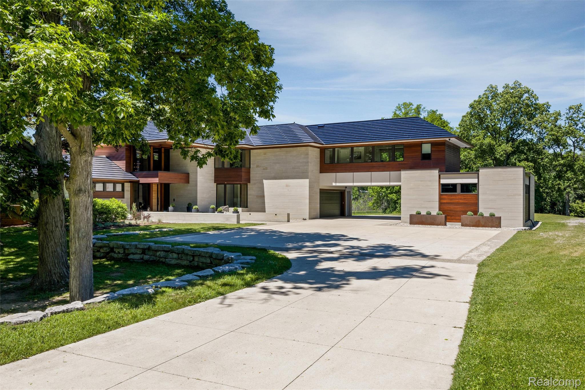 2700 Squirrel Road Bloomfield Hills, MI 48304 - Photo 2 of 83 Contemporary residence with expansive concrete drive, stone retaining wall, and mature trees