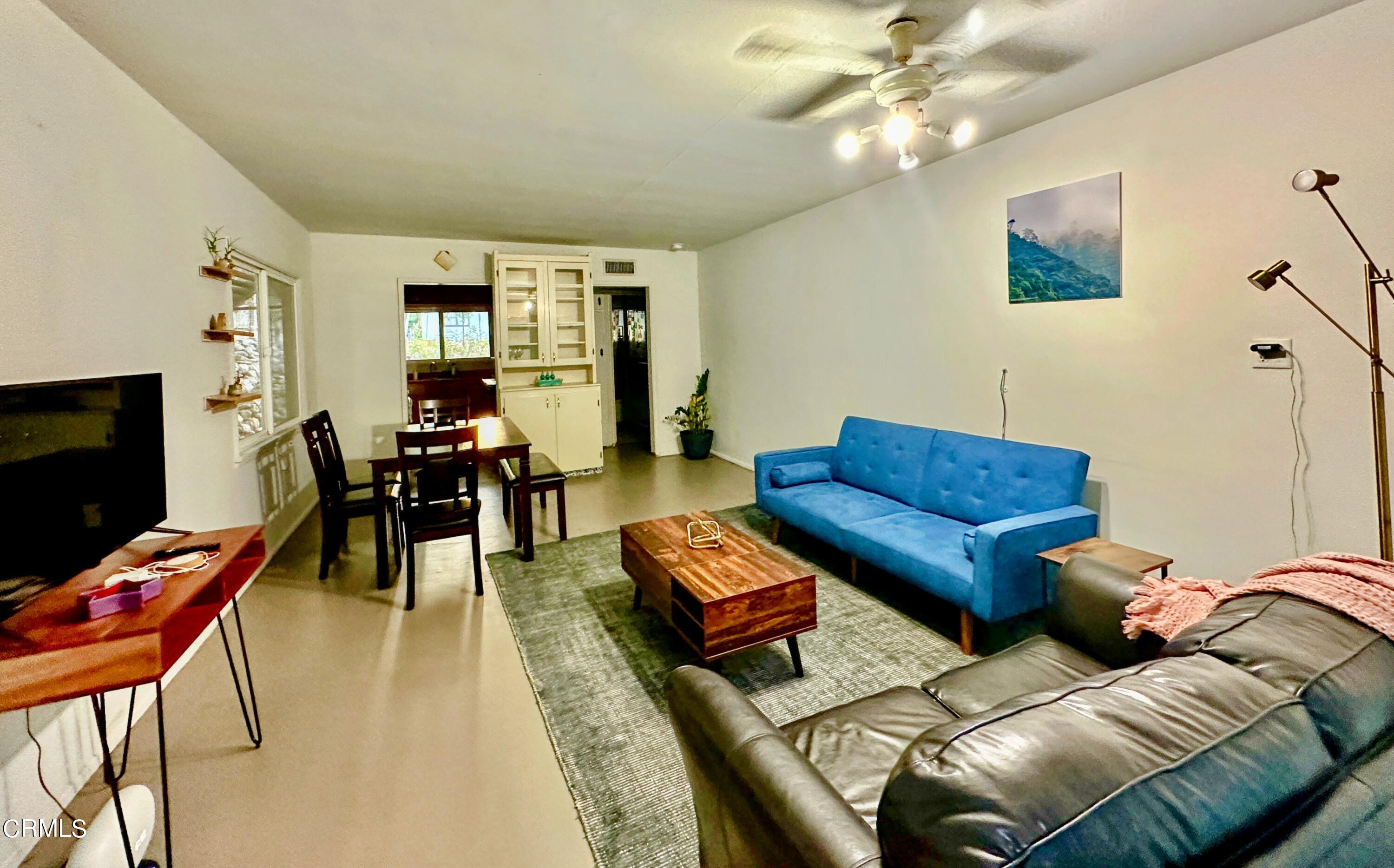 965 Jane Place Pasadena, CA 91105 - Photo 3 of 10 a living room with furniture a ceiling fan and a flat screen tv