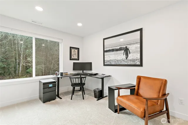 a view of a livingroom with workspace and a couch