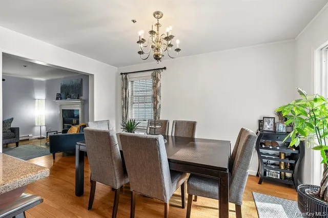 a view of a dining room with furniture and chandelier