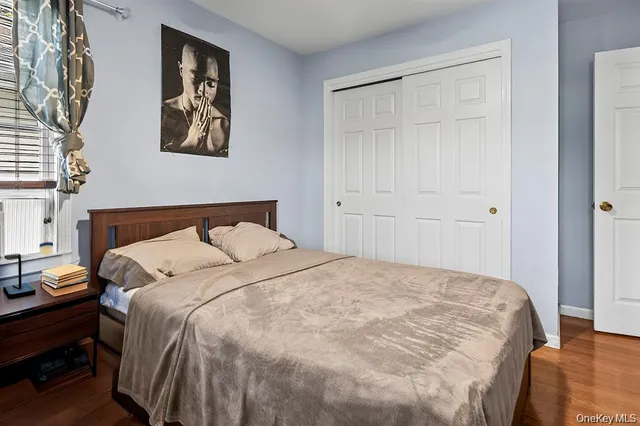 a large bed sitting in a bedroom next to a cabinet