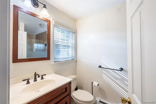a bathroom with a sink toilet and mirror
