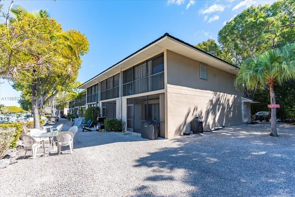 a view of a backyard with sitting area