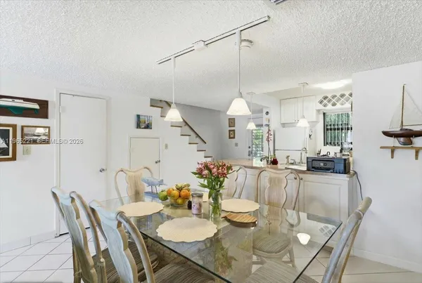 a kitchen with stainless steel appliances granite countertop a sink refrigerator and cabinets