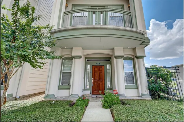 a front view of a house with plants