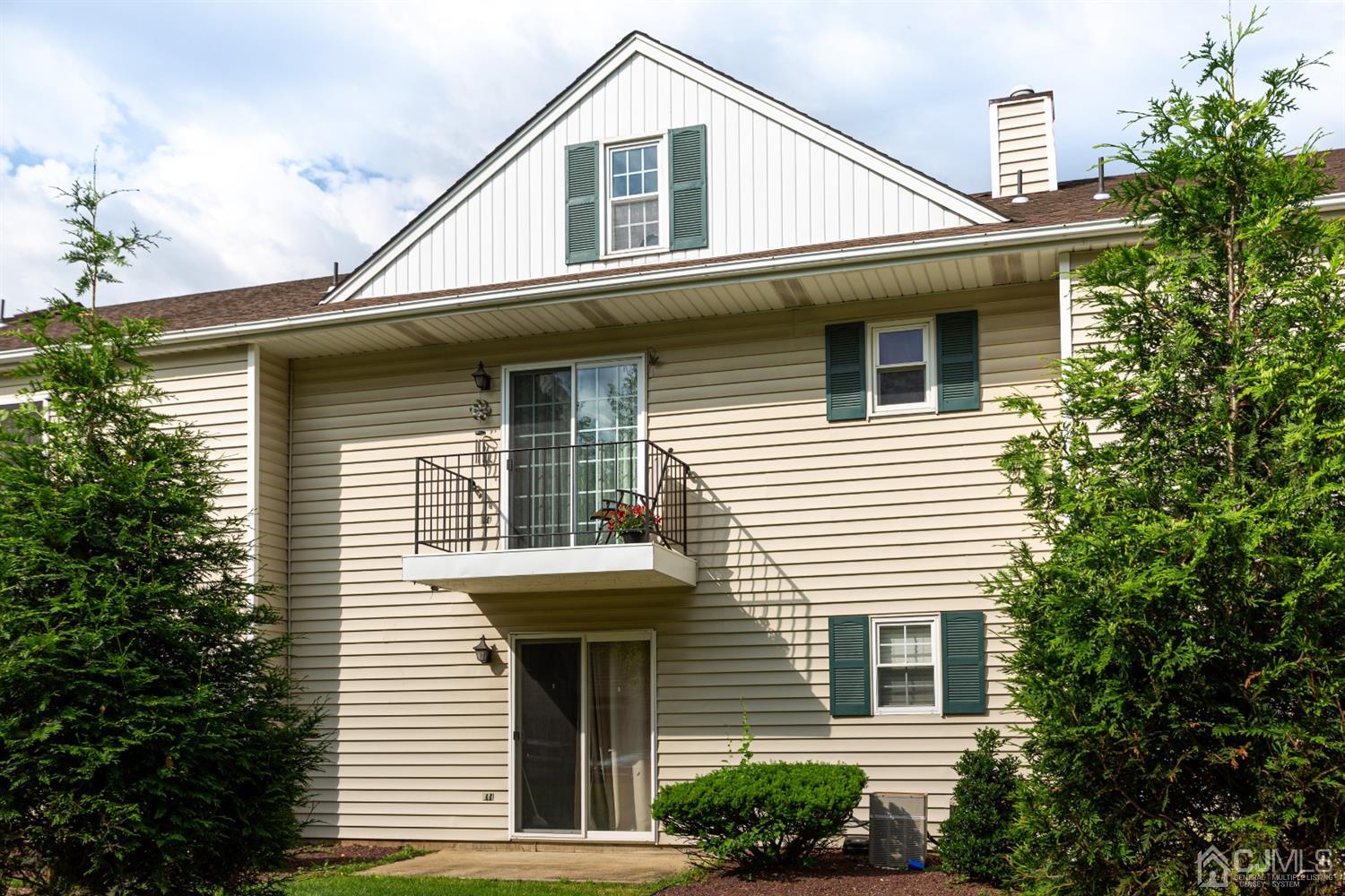 4 Hanover Square Middlesex, NJ 08846 - Photo 14 of 15 a front view of a house with a yard and garage