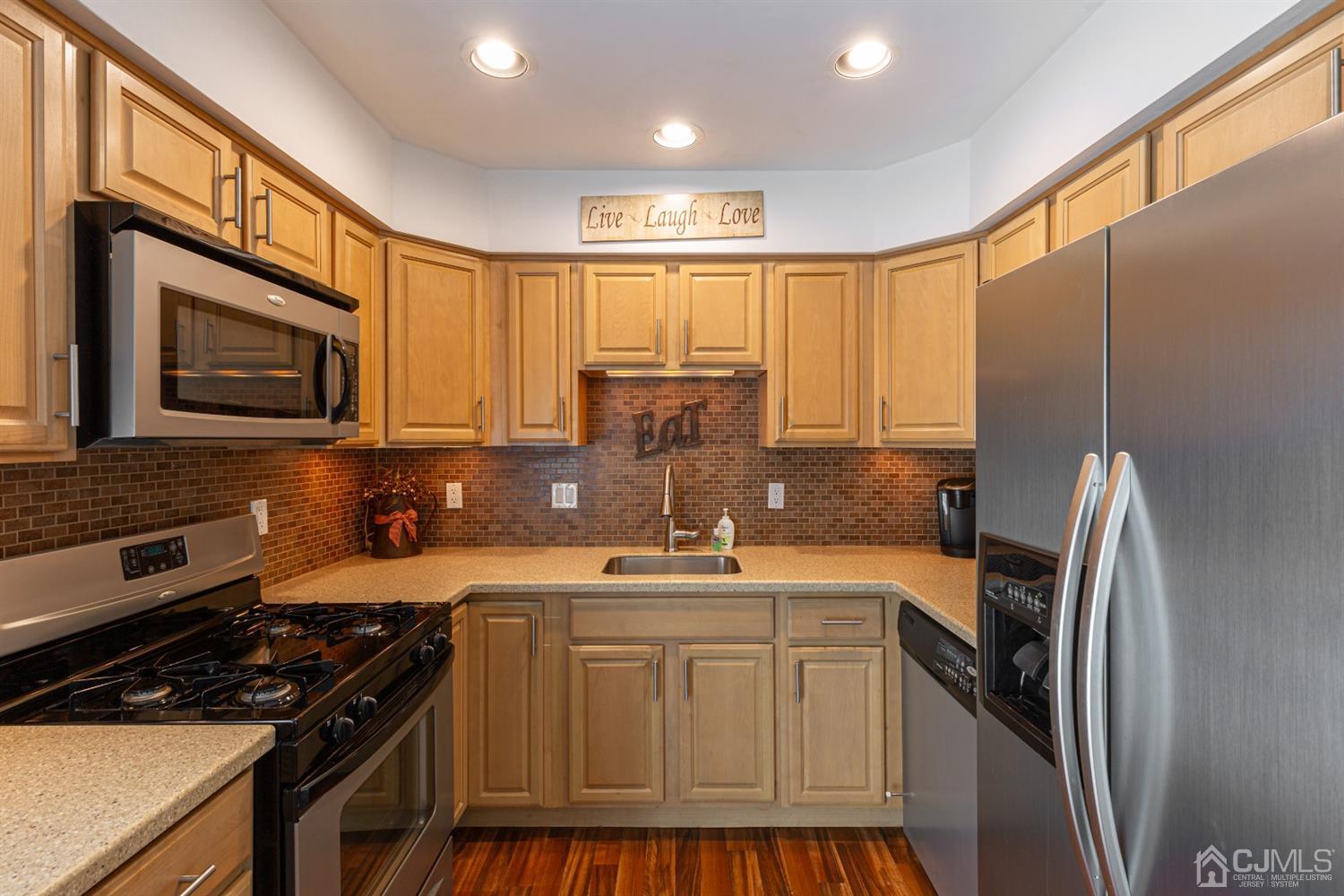 4 Hanover Square Middlesex, NJ 08846 - Photo 8 of 15 a kitchen with kitchen island granite countertop a sink stainless steel appliances and cabinets