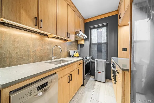 a kitchen with a sink and a refrigerator