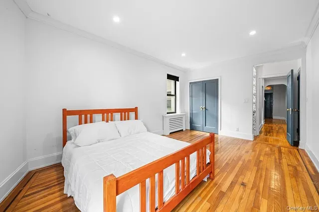 a bedroom with a bed and a view of balcony