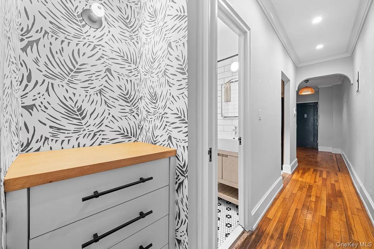 95 Park Terrace East, Unit 1D Manhattan, NY 10034 - Photo 6 of 20 Hall with arched walkways, ornamental molding, hardwood / wood-style floors, and recessed lighting