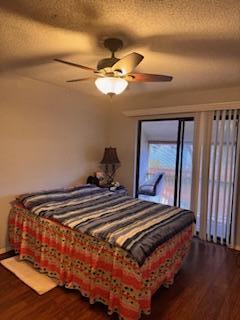 7200 Northwest 2nd Avenue, Unit 87 Boca Raton, FL 33487 - Photo 11 of 17 a bedroom with a bed and wooden floor