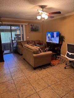 7200 Northwest 2nd Avenue, Unit 87 Boca Raton, FL 33487 - Photo 3 of 17 a living room with furniture and a flat screen tv