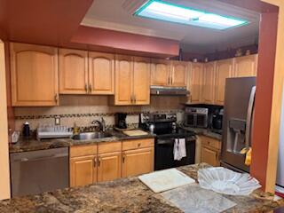 7200 Northwest 2nd Avenue, Unit 87 Boca Raton, FL 33487 - Photo 8 of 17 a kitchen with stainless steel appliances granite countertop a stove top oven a sink dishwasher a refrigerator and cabinets with wooden floor