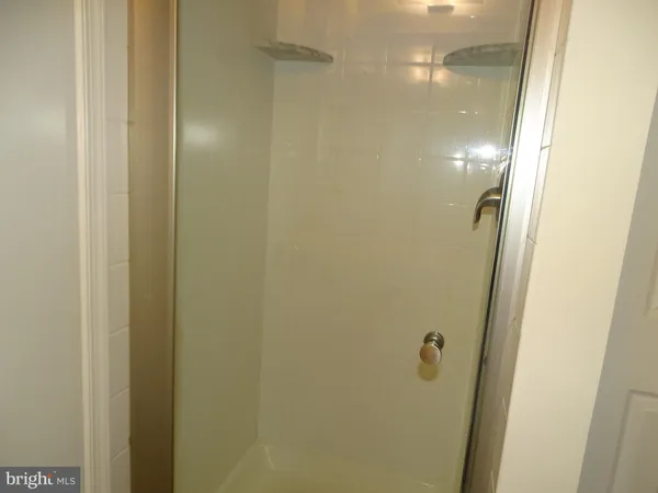a bathroom with a glass shower door