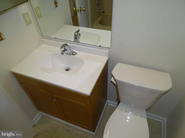 a bathroom with a sink toilet and mirror