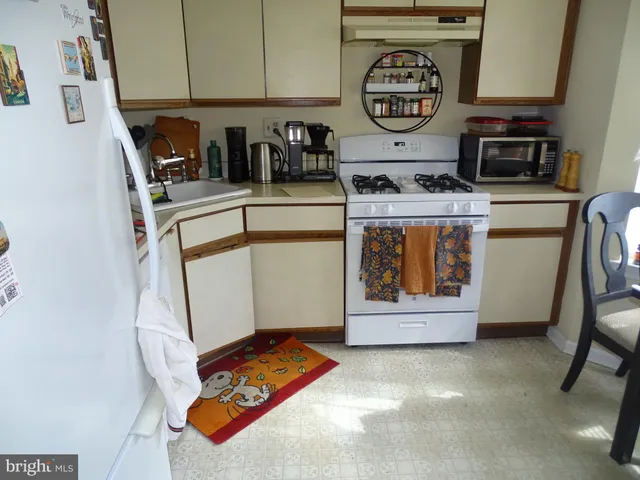 a white refrigerator freezer sitting inside of a kitchen