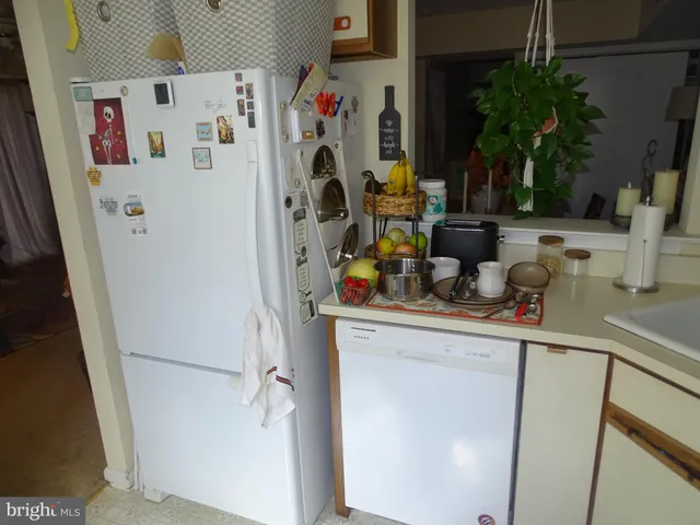 a bed sitting in a bedroom next to a wooden cabinet