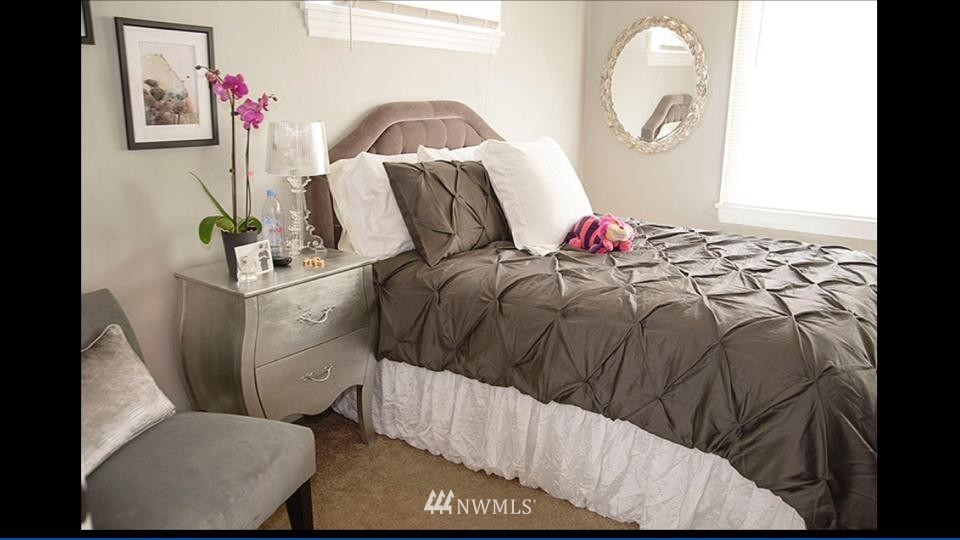 3302 Rucker Avenue Everett, WA 98201 - Photo 13 of 22 a bedroom with a bed and a painting on the wall