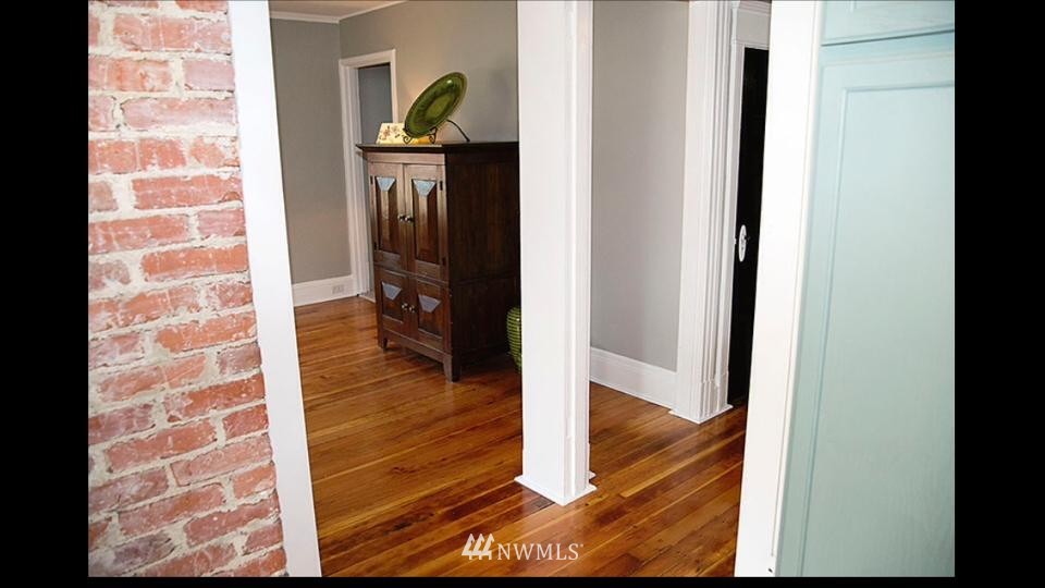 3302 Rucker Avenue Everett, WA 98201 - Photo 15 of 22 a view of a hallway with wooden floor and staircase