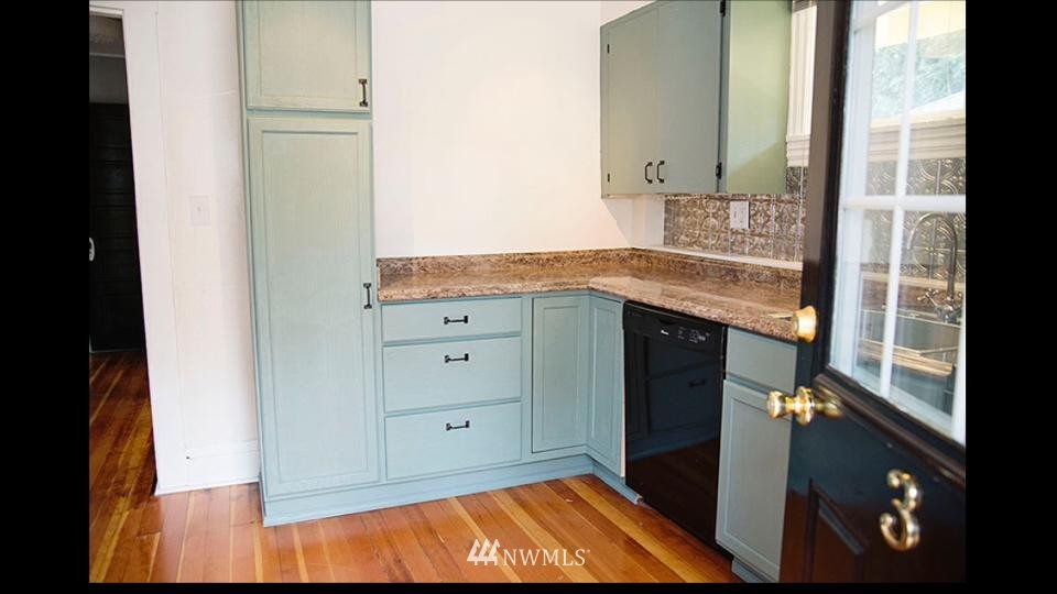 3302 Rucker Avenue Everett, WA 98201 - Photo 17 of 22 a kitchen with granite countertop a refrigerator and a stove