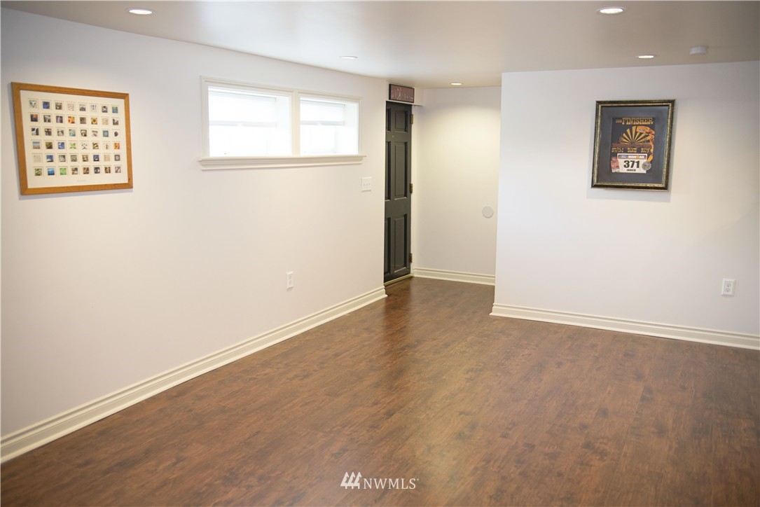 3302 Rucker Avenue Everett, WA 98201 - Photo 4 of 22 an empty room with wooden floor and windows