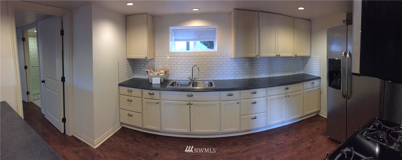 3302 Rucker Avenue Everett, WA 98201 - Photo 7 of 22 a kitchen with stainless steel appliances granite countertop a stove and a refrigerator